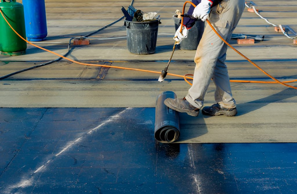 man working on bitumen roofing
