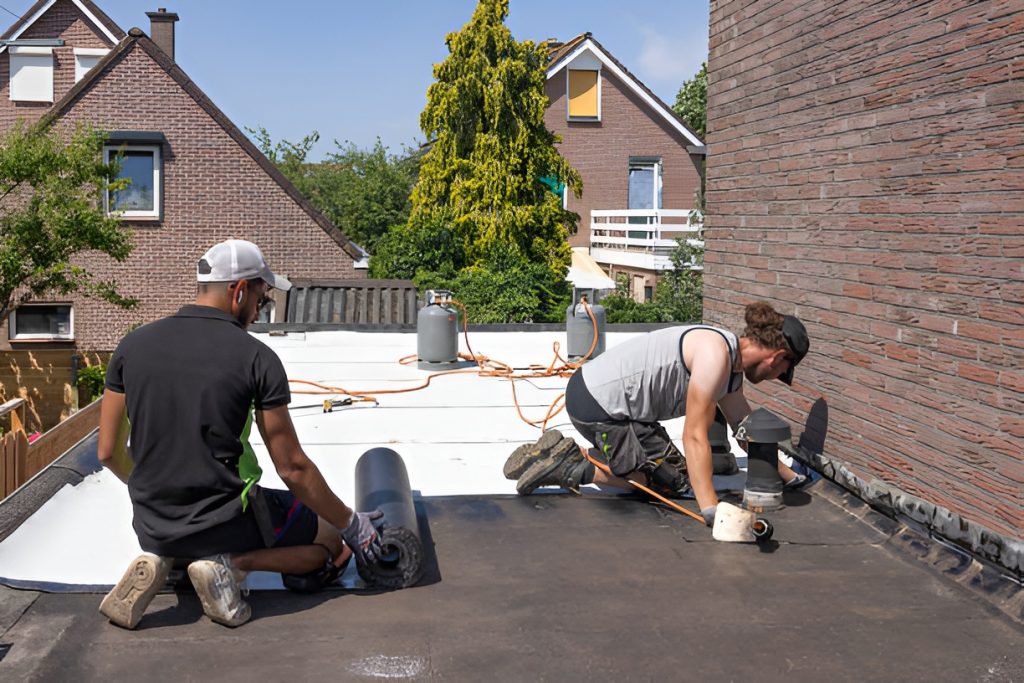 two men working on a flat roof